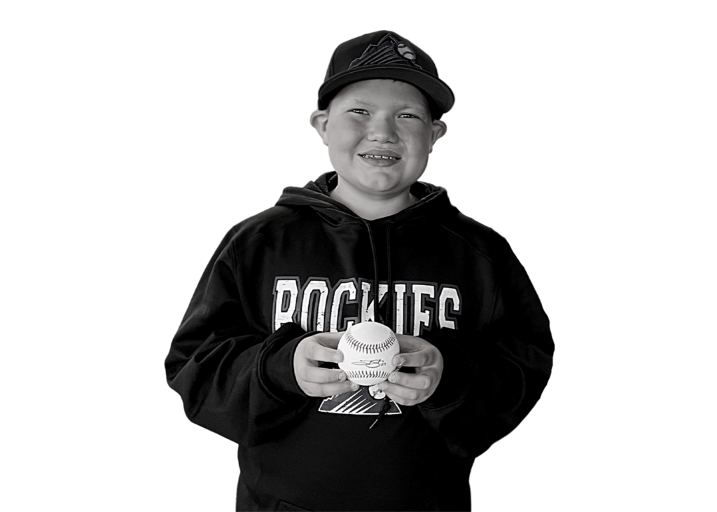 Corbin holding a baseball and smiling