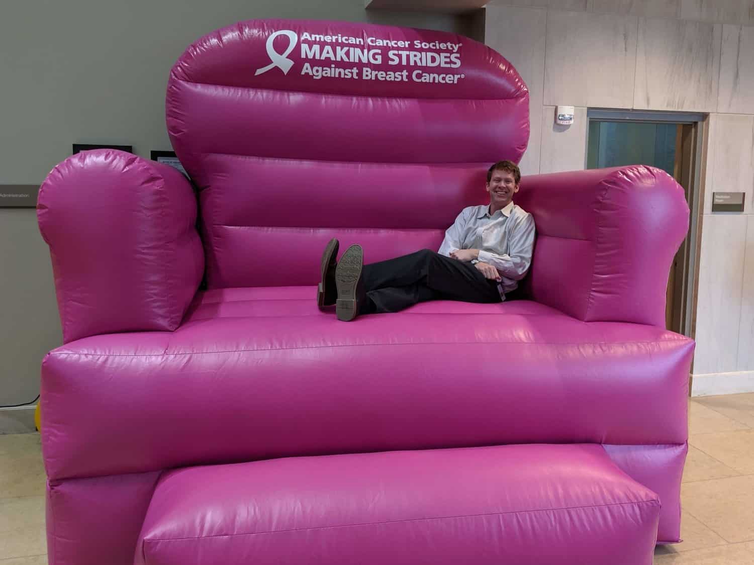 Dr. Mark Storey in a large pink inflatable chair