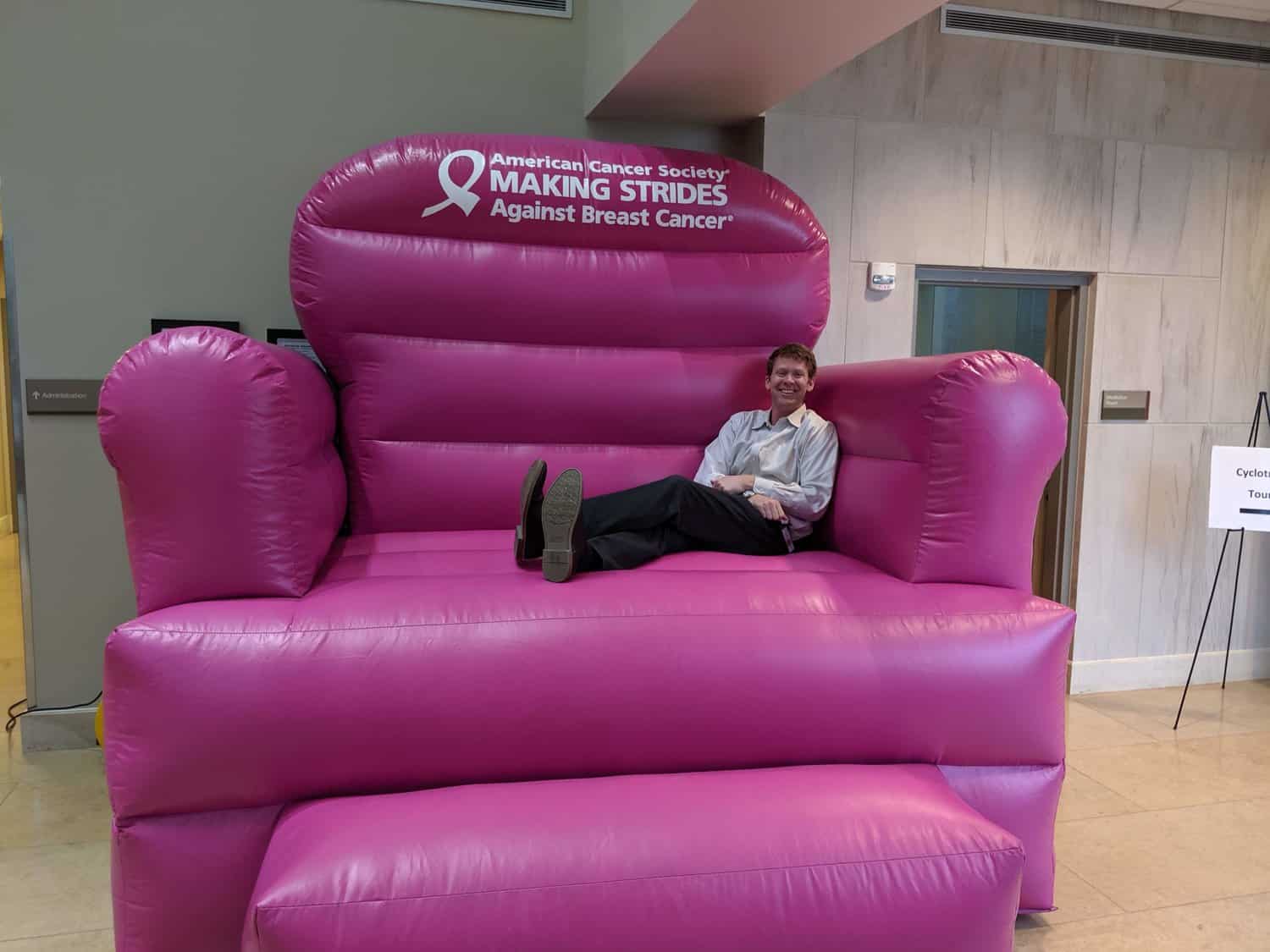 Dr. Mark Storey in a large inflatable pink chair