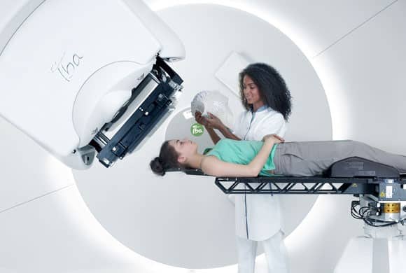Nurse using proton machine on patient